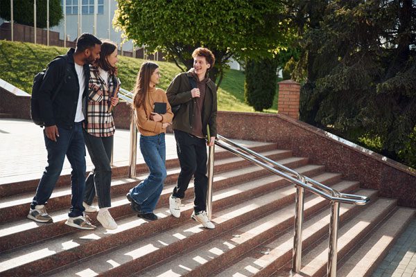 Image of four students walking down steps